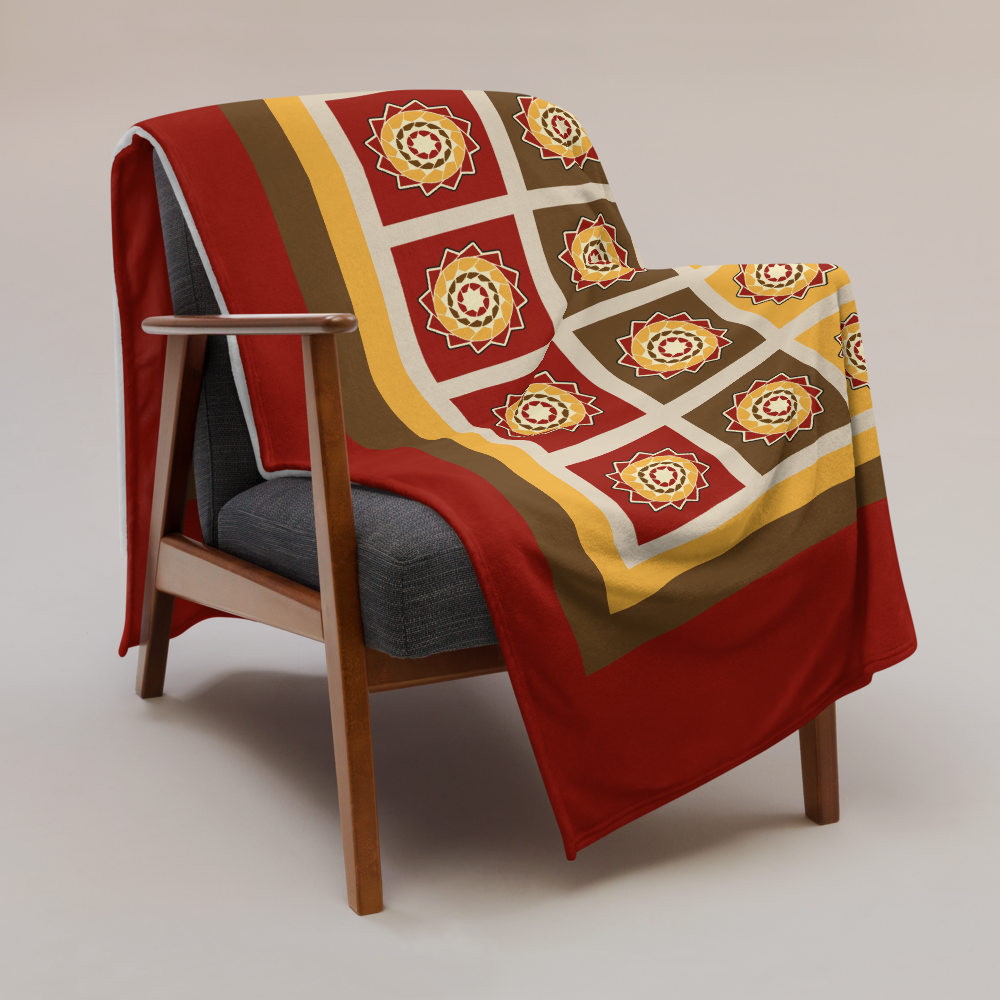 Printfull Pinecone Patchwork Throw Blanket in fall colors, showcasing cozy, colorful fabric pattern on a lifestyle setting.